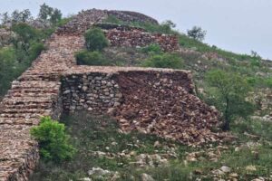 Two sections of a 2600 year old cyclopean wall collapse in India's ancient city of Rajgir.